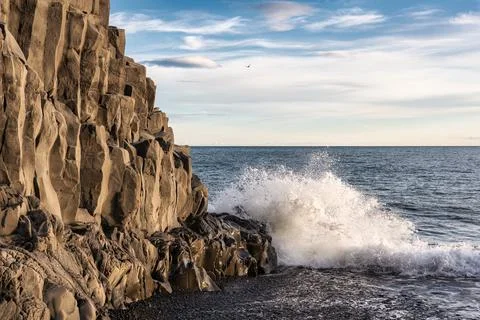 Wave hitting on Halsanefhellir cave with basalt rock formation on black san.. Stock Photos