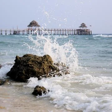 Wave Hitting Rock Stock Photos