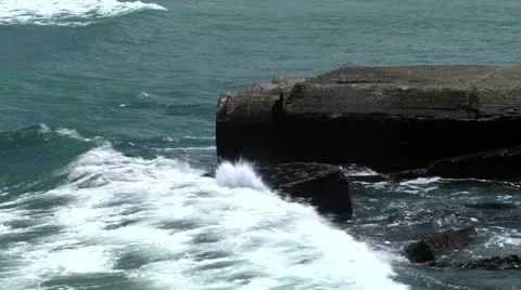 Wave hitting rock wall Stock Footage 21687761
