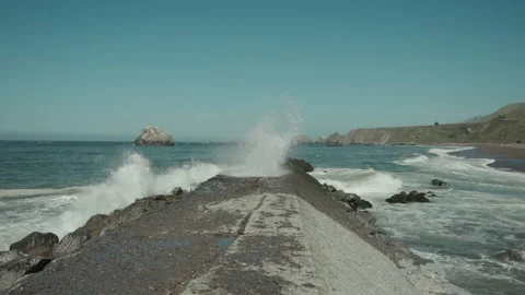 Wave hitting sea wall in slow motion Stock Footage 308904973