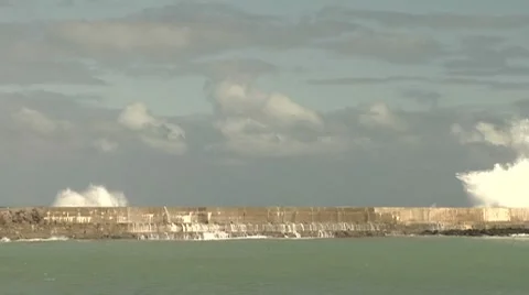 Wave just breaching the seawall Stock Footage 8509745