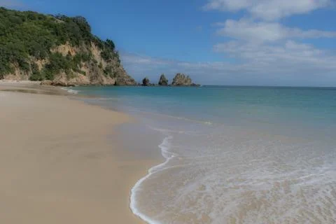 Wave lapping against empty beach 스톡 사진