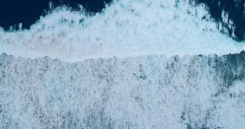 Wave leaving stringy surf in its wake as it breaks vertical aerial shot 4K Stock-Footage 87573693