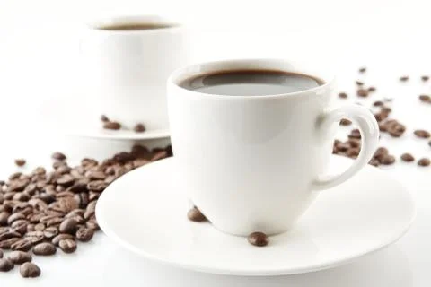 Wave made of coffee beans with cups of coffee on white Stock Photos