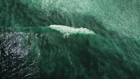 Wave in the ocean from a bird's eye view. Deep ocean blue and fluffy wave. Stock Footage 246513403
