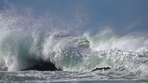 Wave ocean splashing rocks. foam fizz sea. reefs. blue sky Stock Footage 244857902