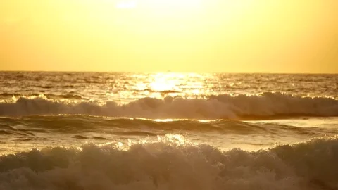 Wave or surf crashing on beach. in the tropical beach with Golden sunlight at Stock Footage 82188519