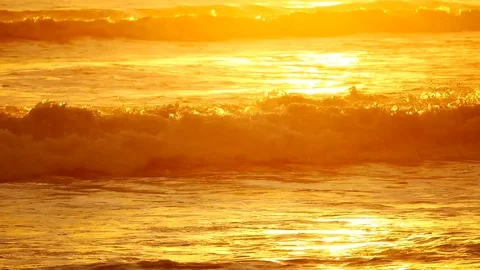 Wave or surf crashing on beach. in the tropical beach with Golden sunlight at Stock Footage 82188563