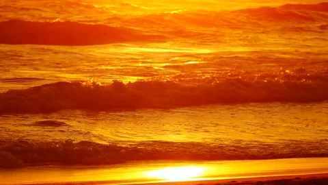 Wave or surf crashing on beach. in the tropical beach with Golden sunlight at Stock Footage 82188580