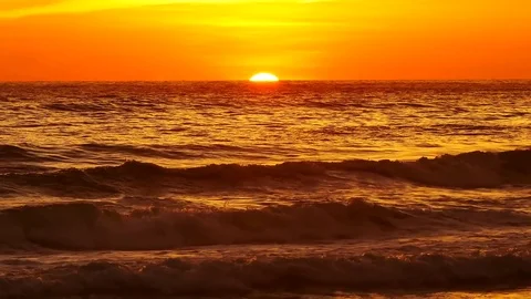 Wave or surf crashing on beach. in the tropical beach with Golden sunlight at Stock Footage 82188642