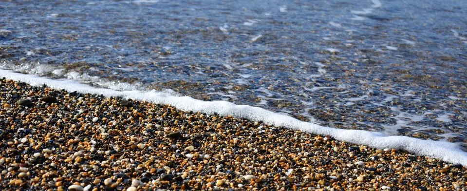 Wave Over Pebbles Stock Photos