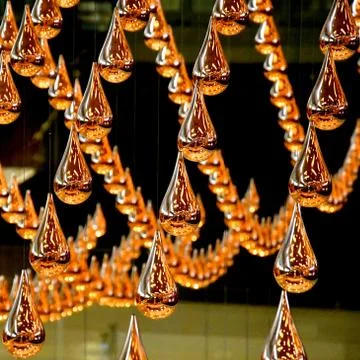 Wave pattern of bronze droplets Stock Photos