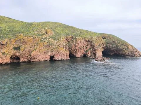 Wave Patterns Along the Rocky Coast of a Hidden Island Stock Photos