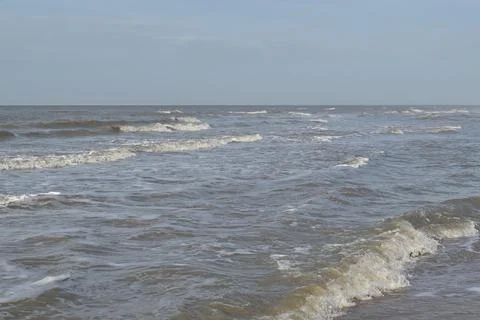 Wave patterns rushing to the shore at Den Helder in the Netherlands Stock Photos