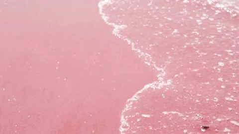 Wave on Pink Red Sand Close-up, Sea and Pink Sand. Waves in the Ocean Roll on Re Stock Footage 245272903
