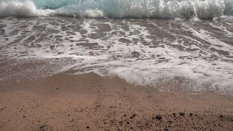 Wave reaching the shore on the beach in slow motion Stock Footage 111762713