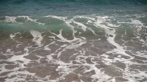 Wave reaching the shore on the beach in slow motion Stock Footage 111763047