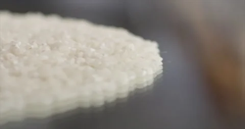 A wave of rice falls on a mirror surface Video stock 197865677
