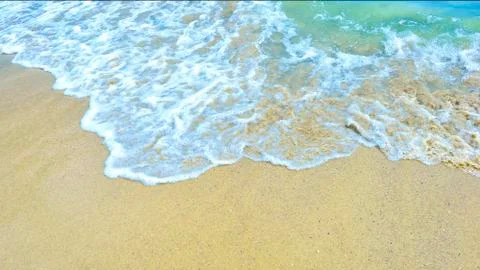 Wave roll into beach with white clean foam Stock Photos