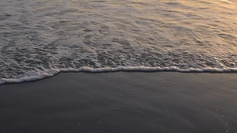 Wave rolling onto black sand slow motion 動画素材 91197227