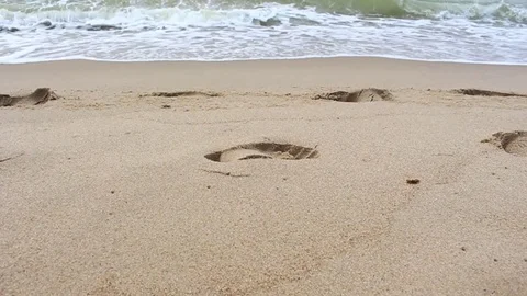 Wave rolls on the beach sand1 Stock Footage 77650797