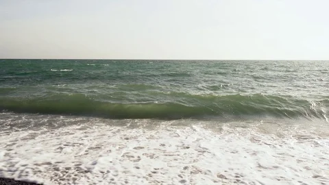 Wave rolls on the flat side of the sea Stock Footage 82527531