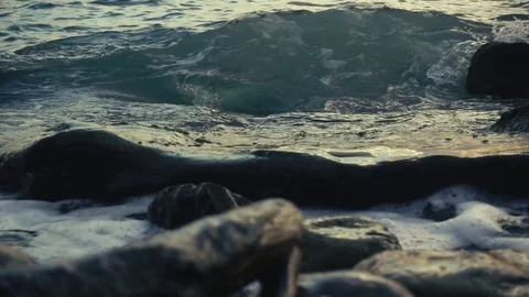 A wave rolls over a large stone slow motion Stock-Footage 81353008