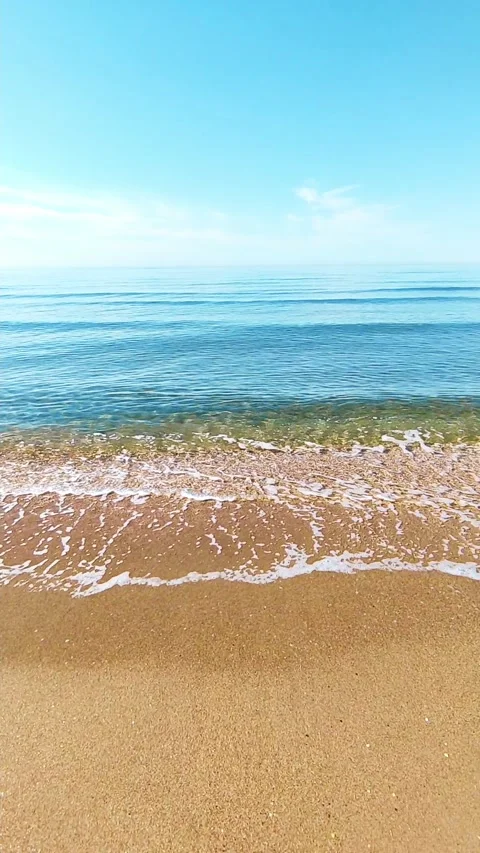 Wave rolls over the sandy shore and the beautiful sky in the background Stock Footage 154409251