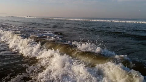 Wave rolls in the rays of the dawn sun on the tropical coast of the ocean.  Stock Footage 168494562