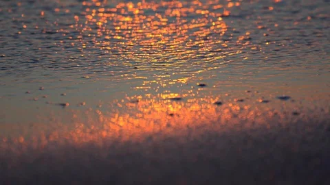 Wave runs into the sand at sunset 스톡 동영상 98680367