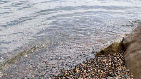 Wave Rushing Toward Pebble Stone Beach. Stony Seashore. Natural Background Of A  Stock Footage 203889373