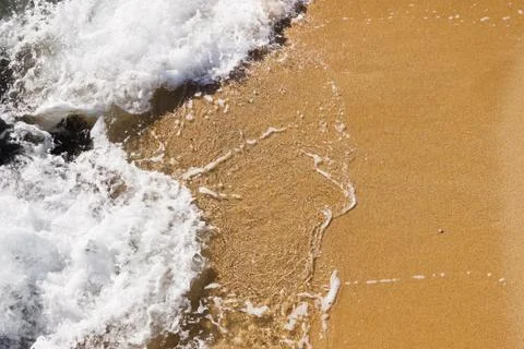 Wave in the sand of the beach background Stock Photos