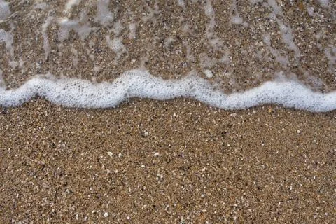 Wave on the sand beach background Stock Photos