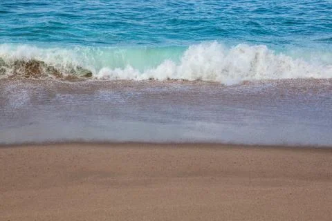 Wave on the sand beach background Stock Photos