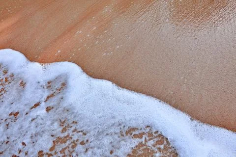 Wave On Sandy Beach. Background. Splash of waves on the sandy beach. foam, su Stock Photos