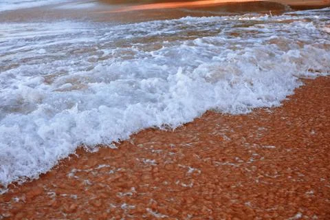 Wave On Sandy Beach. Background. Splash of waves on the sandy beach. foam, su Stock-Fotos