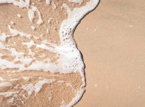 Wave on sandy beach Stock Photos