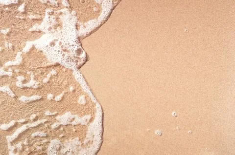 Wave on sandy beach Stock Photos