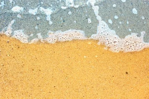 Wave on sandy beach Stock Photos