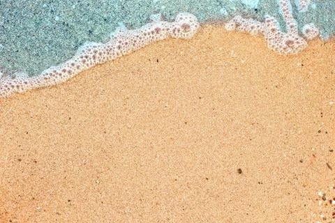 Wave on sandy beach Stock Photos