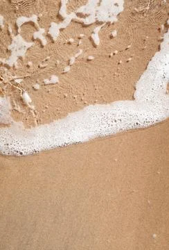 Wave on sandy beach Stock Photos