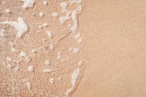 Wave on sandy beach Stock Photos