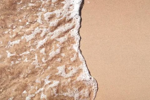 Wave on sandy beach Stock Photos