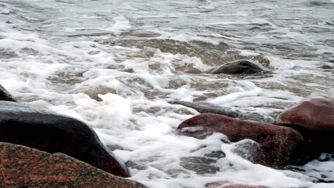 Wave of the sea hitting the rocks. A dark autumn day. Stock Footage 220328564