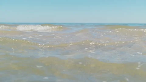 Wave of sea on sandy beach close up Summer Stock Footage 134631359