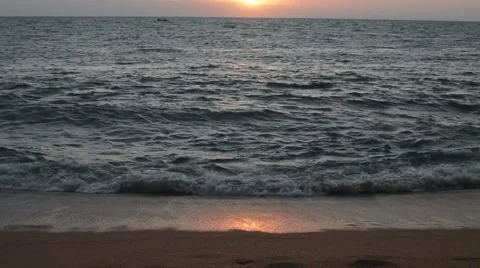 Wave of the sea on the sandy beach at sunset Видео 49672823