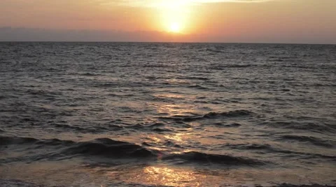 Wave of the sea on the sandy beach at sunset Видео 49672866