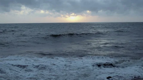 Wave of the sea on the sandy beach at sunset Stock Footage 53314162
