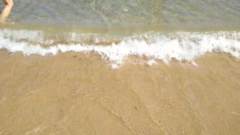 Wave on the shoreline close-up with clean sand and water Stock Footage 241446618