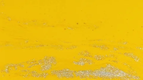 Wave of silver in yellow vibrant bright paint and oil color swirls entropy Stock Footage 81942994